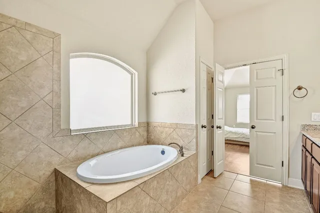 a bathroom with a bathtub and a shower