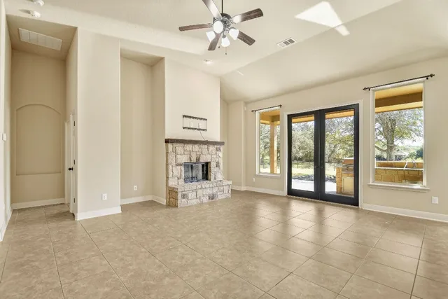 a view of an empty room with window and cabinet
