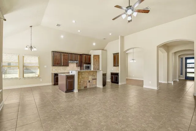 a view of a kitchen with kitchen island stainless steel appliances wooden floor and window