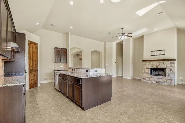 a large kitchen with stainless steel appliances a stove and a refrigerator