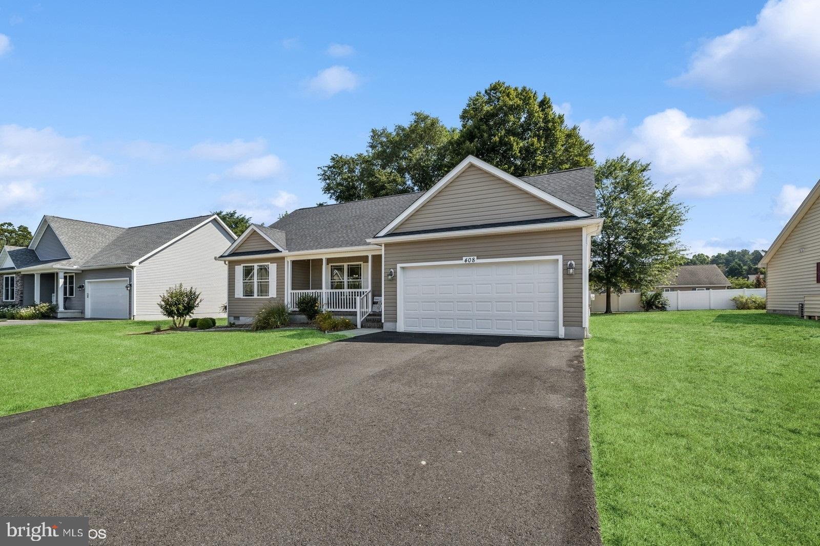 408 Summit Drive Seaford, DE 19973 - Photo 1 of 32 a front view of a house with a yard and garage