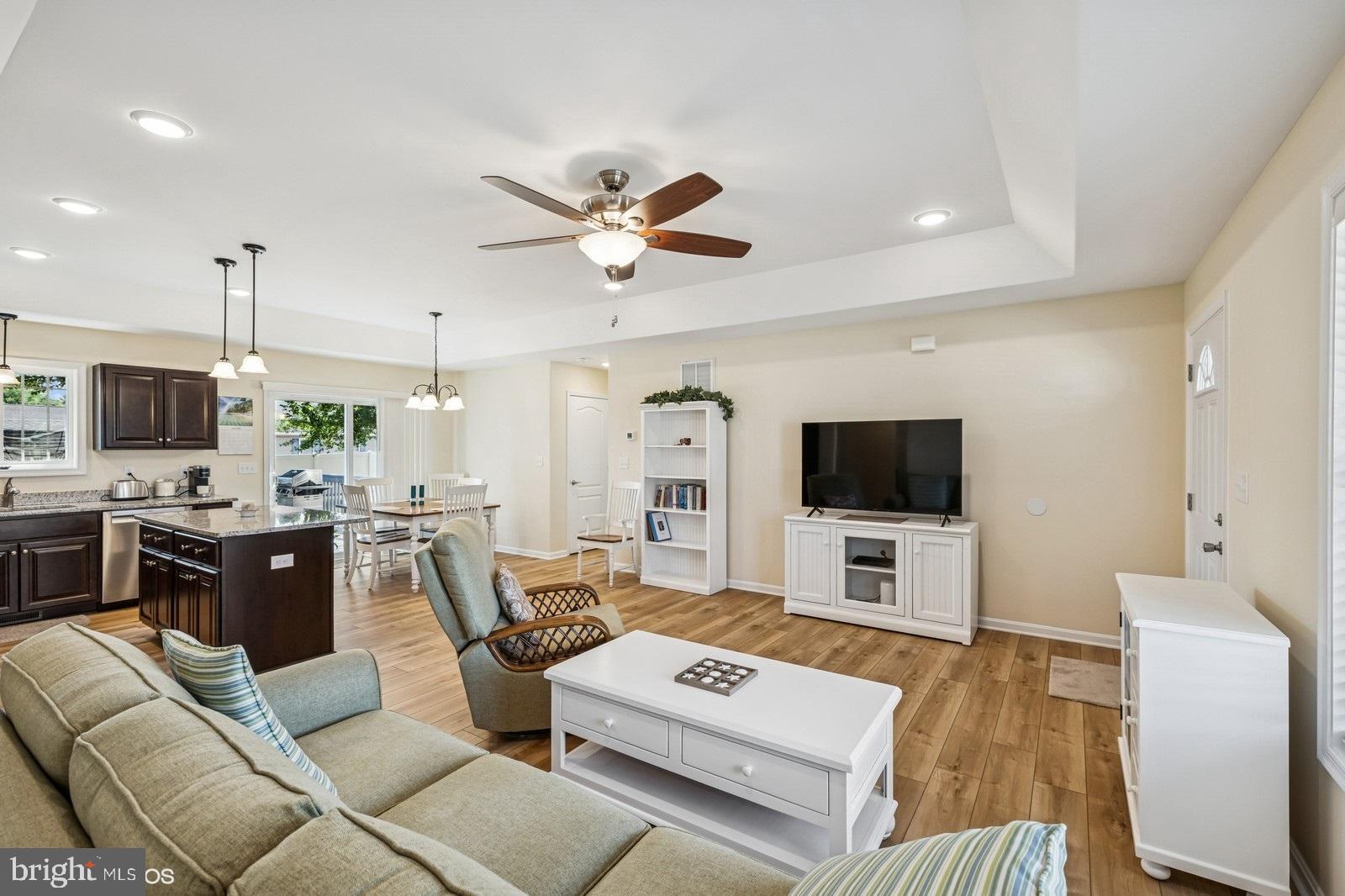 408 Summit Drive Seaford, DE 19973 - Photo 13 of 32 a living room with furniture a flat screen tv and kitchen view