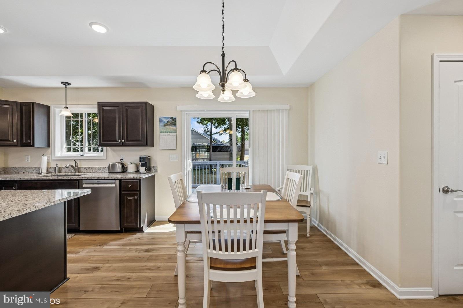 408 Summit Drive Seaford, DE 19973 - Photo 14 of 32 a view of a dining room with furniture a chandelier and wooden floor