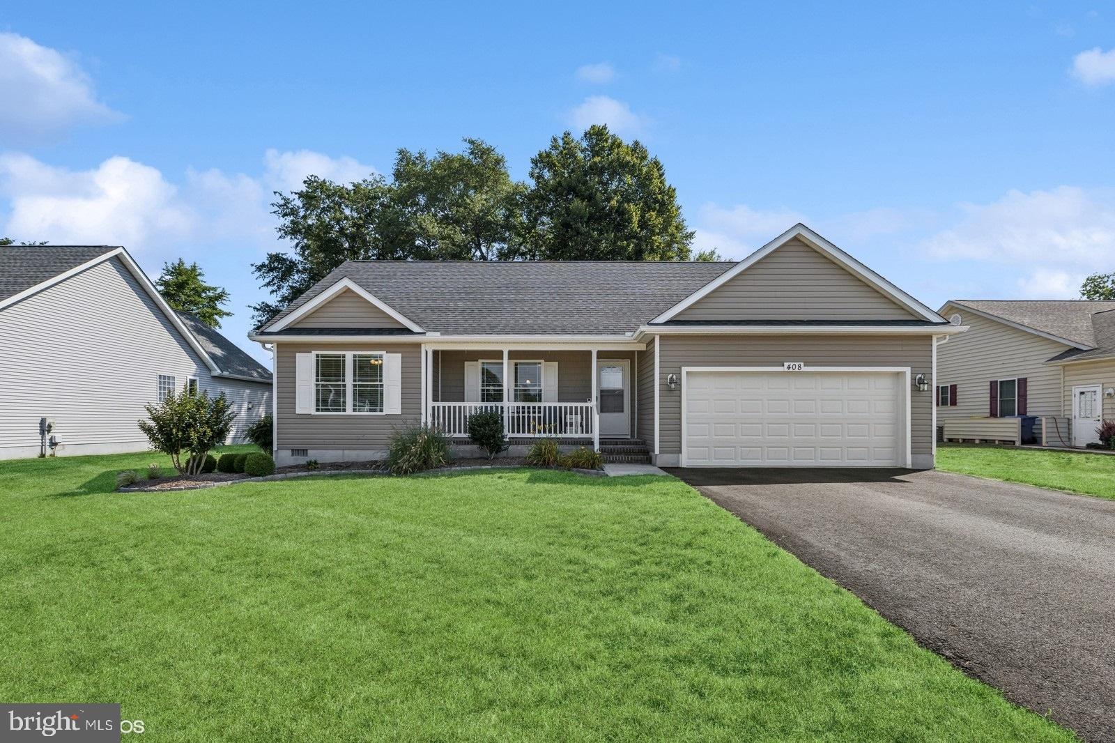 408 Summit Drive Seaford, DE 19973 - Photo 2 of 32 a front view of a house with a yard and garage