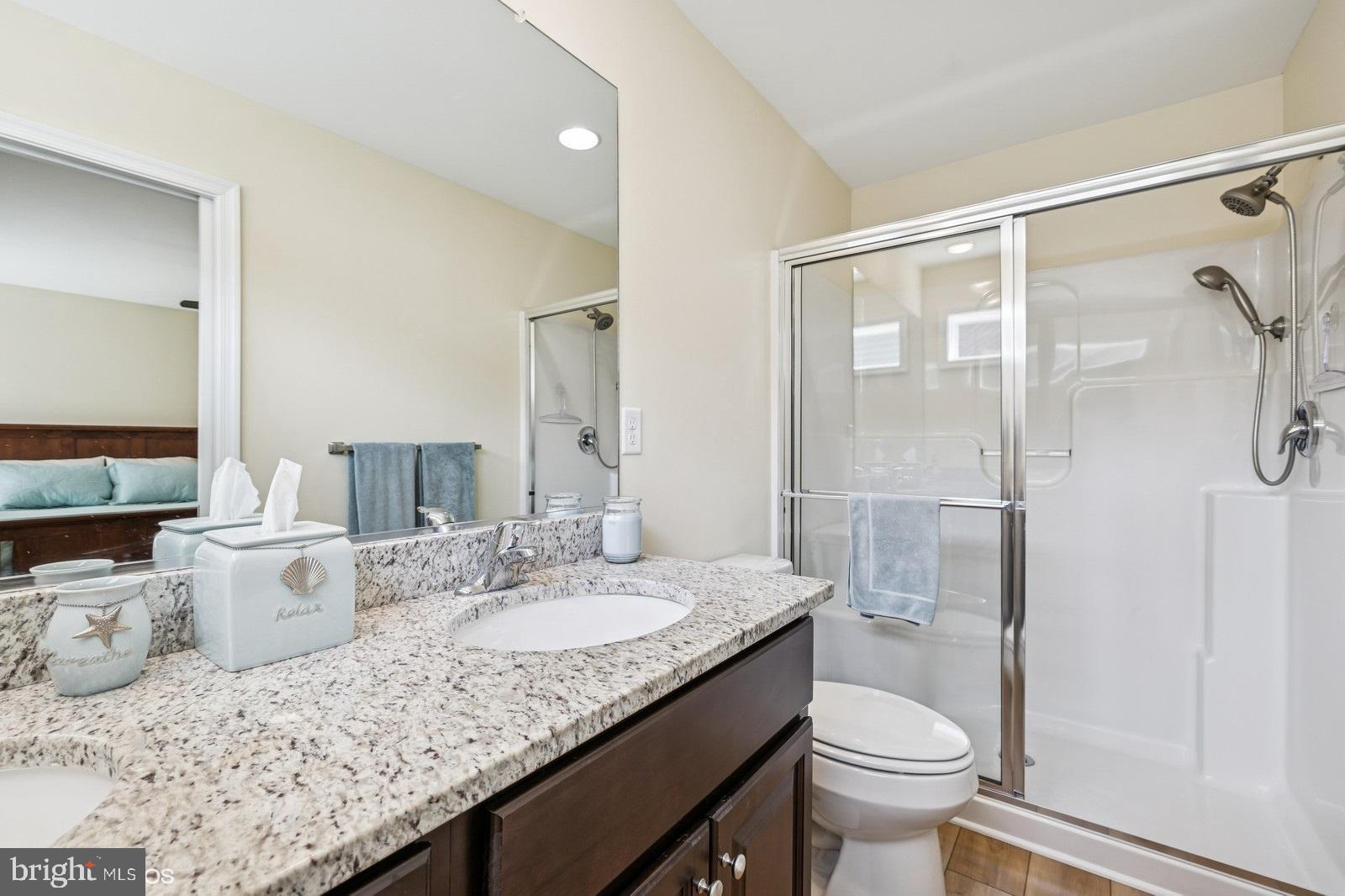408 Summit Drive Seaford, DE 19973 - Photo 24 of 32 a bathroom with a granite countertop sink toilet and shower