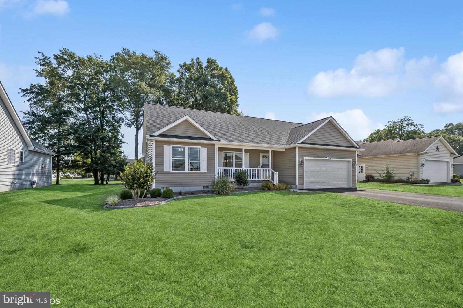 408 Summit Drive Seaford, DE 19973 - Photo 3 of 32 a front view of a house with a yard and trees