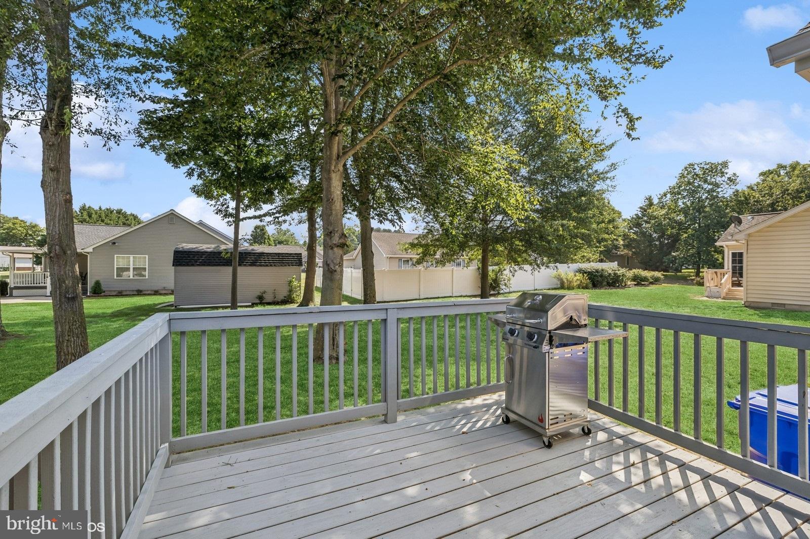 408 Summit Drive Seaford, DE 19973 - Photo 7 of 32 a view of a deck with wooden floor and fence next to a yard
