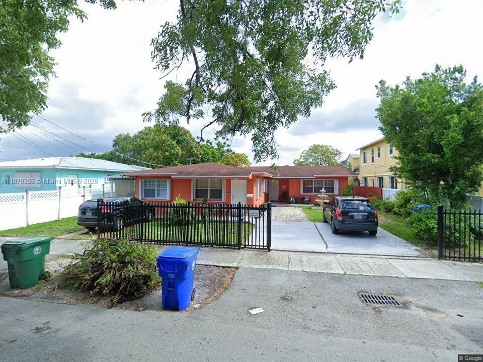 a front view of a house with a garden and fire pit
