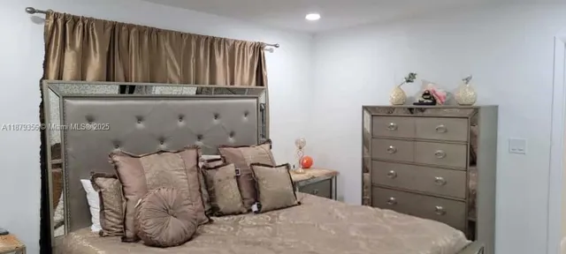 a bedroom with a bed and a cabinet