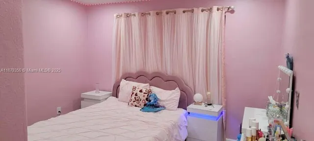 a bedroom with a bed and a curtain