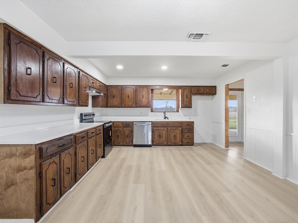 514 Dallas Street Italy, TX 76651 - Photo 11 of 34 a large kitchen with stainless steel appliances sink a microwave and cabinets