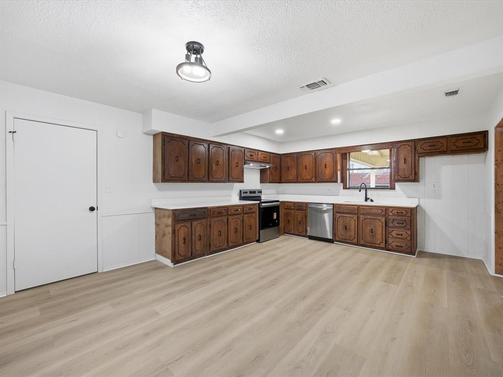 514 Dallas Street Italy, TX 76651 - Photo 13 of 34 a large kitchen with stainless steel appliances double vanity and a refrigerator