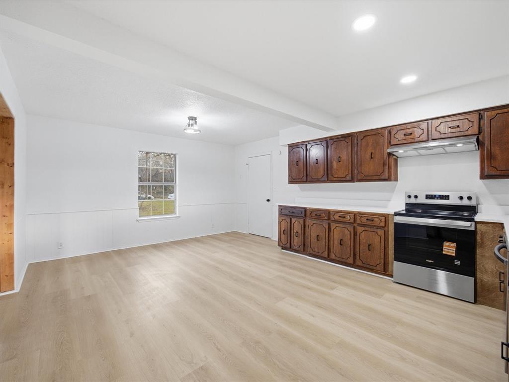 514 Dallas Street Italy, TX 76651 - Photo 14 of 34 a kitchen with stainless steel appliances granite countertop a stove a sink and a microwave