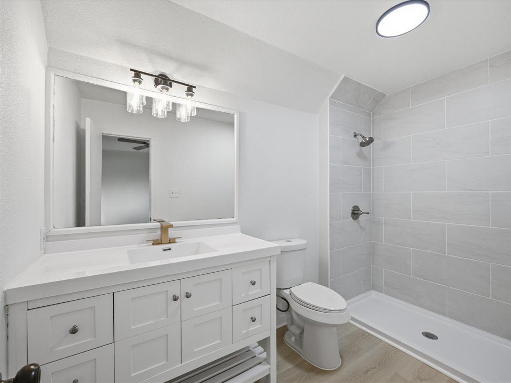 514 Dallas Street Italy, TX 76651 - Photo 17 of 34 a bathroom with a sink a toilet and shower