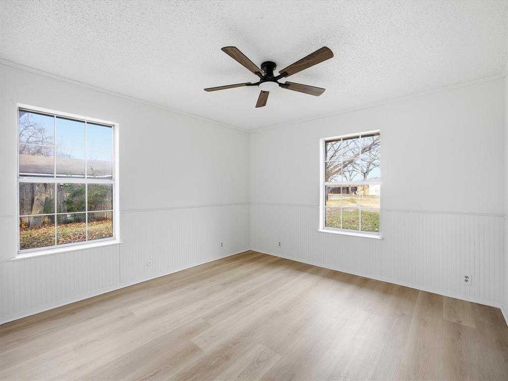 514 Dallas Street Italy, TX 76651 - Photo 19 of 34 a view of a big room with wooden floor and windows