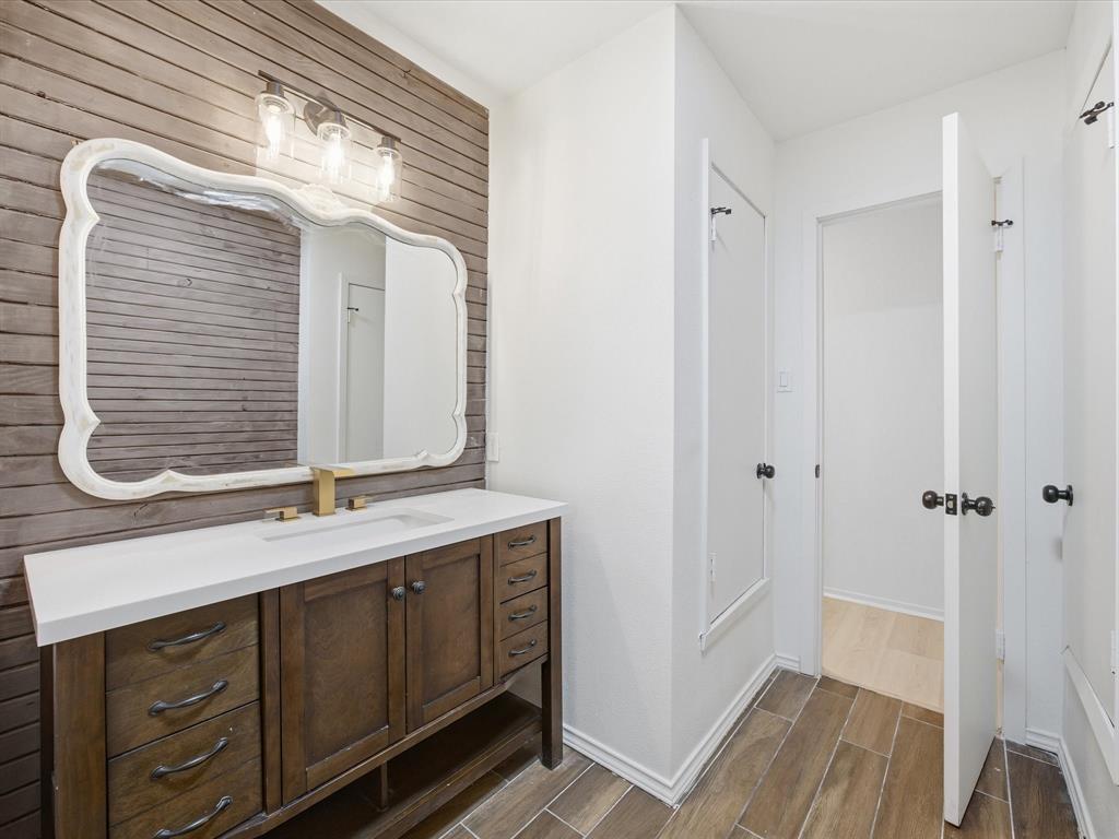 514 Dallas Street Italy, TX 76651 - Photo 23 of 34 a bathroom with a double vanity sink and a mirror