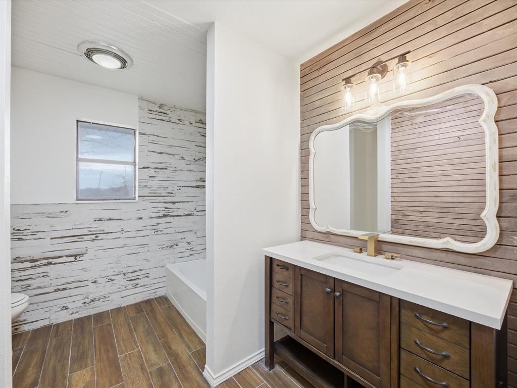 514 Dallas Street Italy, TX 76651 - Photo 24 of 34 a bathroom with a sink and a mirror
