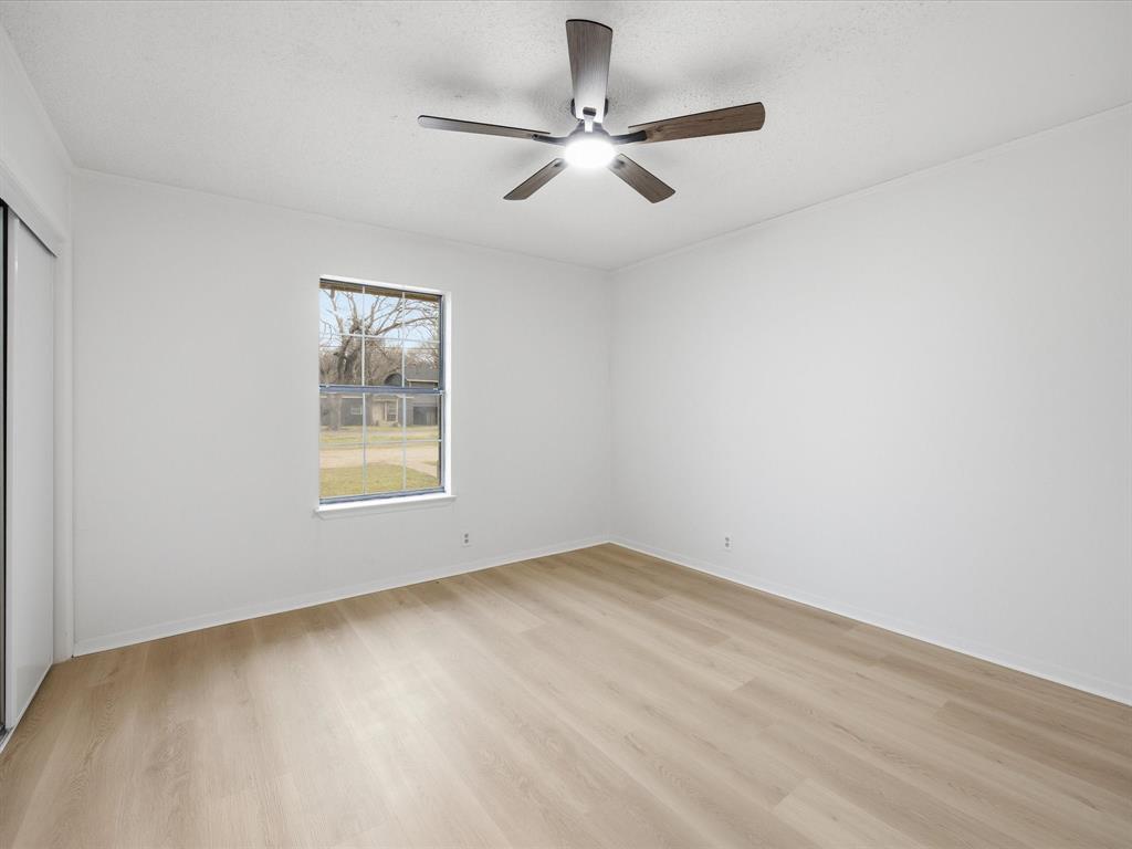 514 Dallas Street Italy, TX 76651 - Photo 26 of 34 an empty room with a window and a ceiling fan