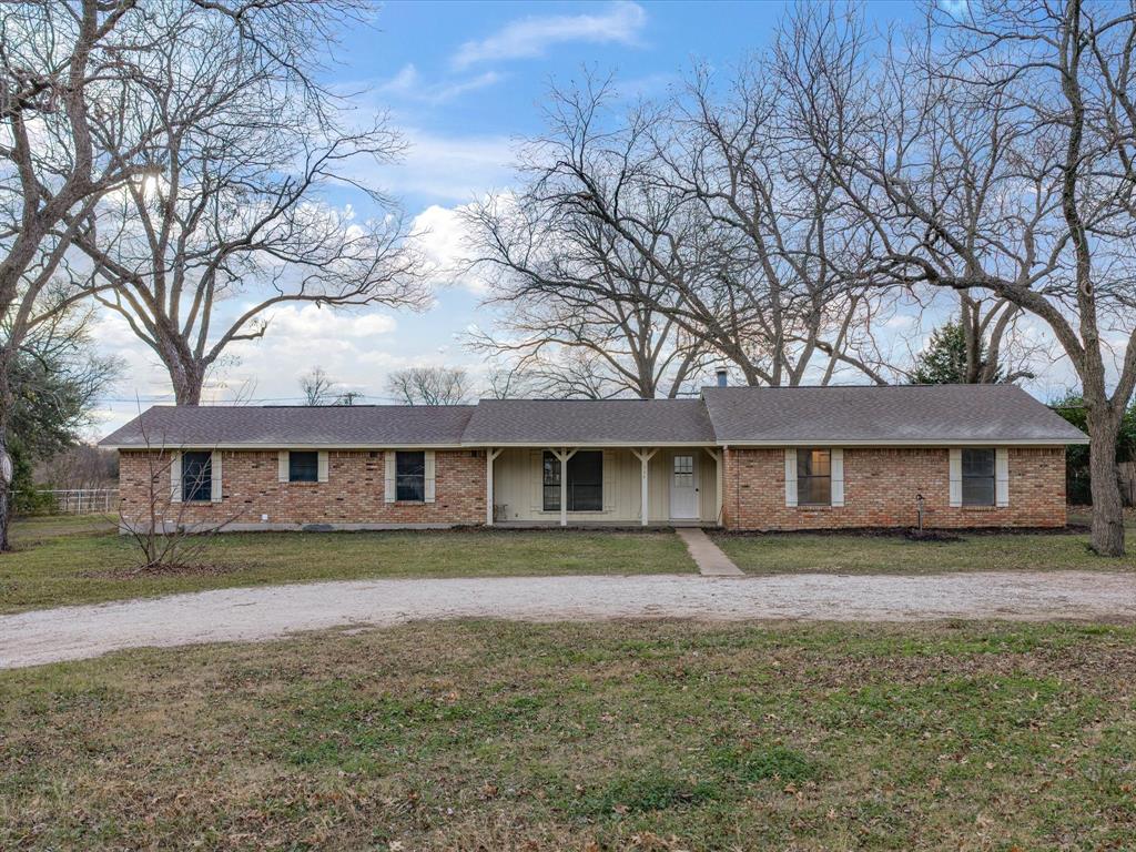 514 Dallas Street Italy, TX 76651 - Photo 3 of 34 a front view of a house with a yard