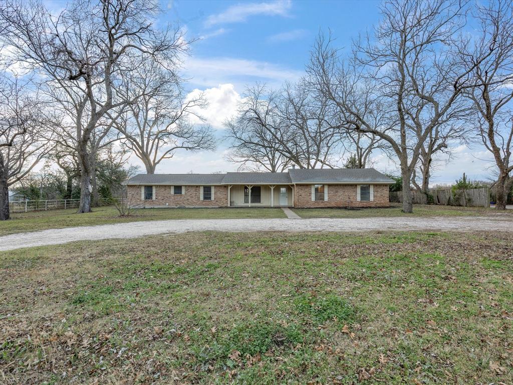 514 Dallas Street Italy, TX 76651 - Photo 4 of 34 a front view of a house with a yard