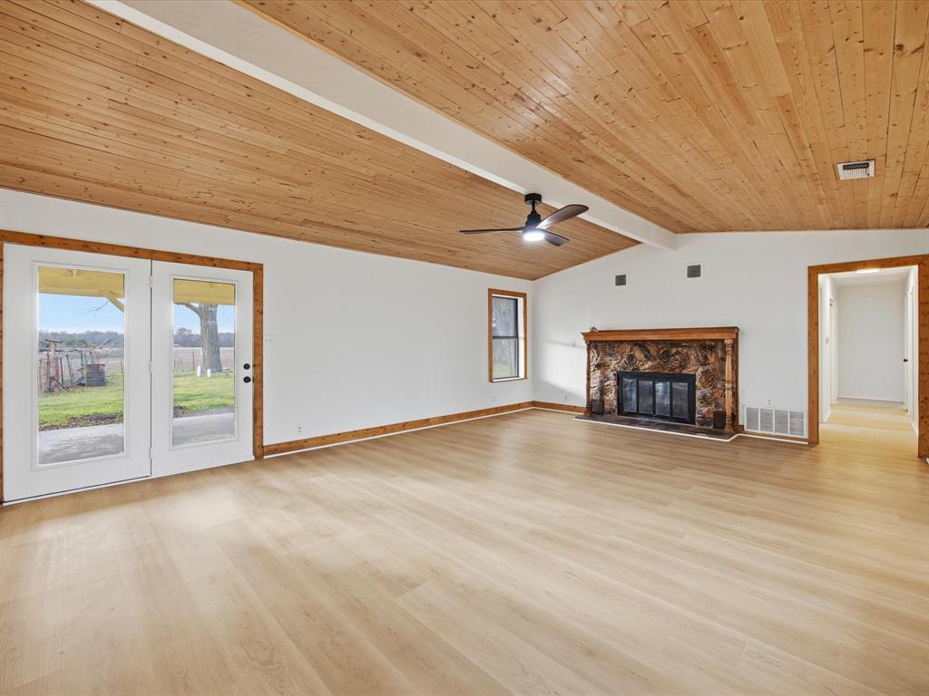 514 Dallas Street Italy, TX 76651 - Photo 6 of 34 a view of an empty room with a fireplace and a window