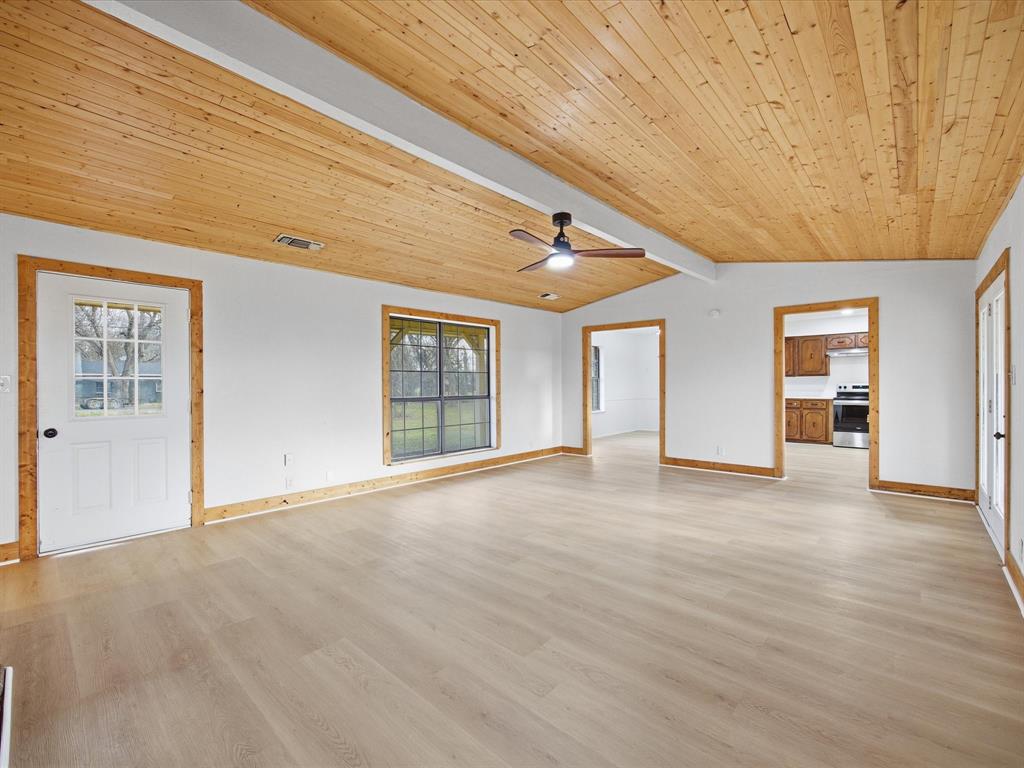 514 Dallas Street Italy, TX 76651 - Photo 7 of 34 a view of an empty room with wooden floor and a window