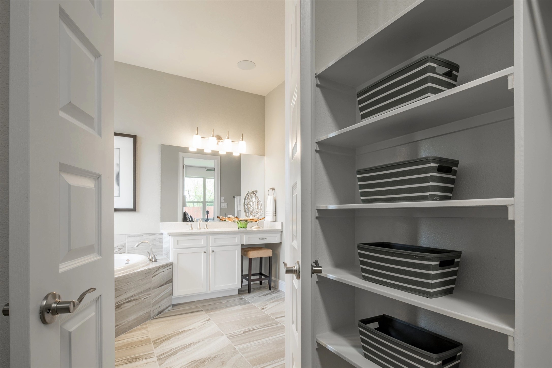 1229 Terrace View Drive Georgetown, TX 78628 - Photo 9 of 17 Clean lines and a spacious layout define this well-appointed bathroom with built-in shelving.