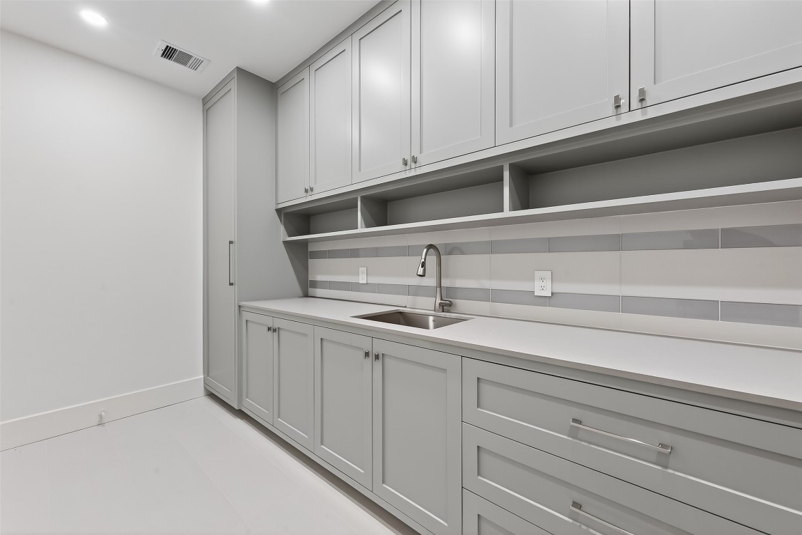 6534 Corbin Street Houston, TX 77055 - Photo 10 of 50 a kitchen with white cabinets and sink