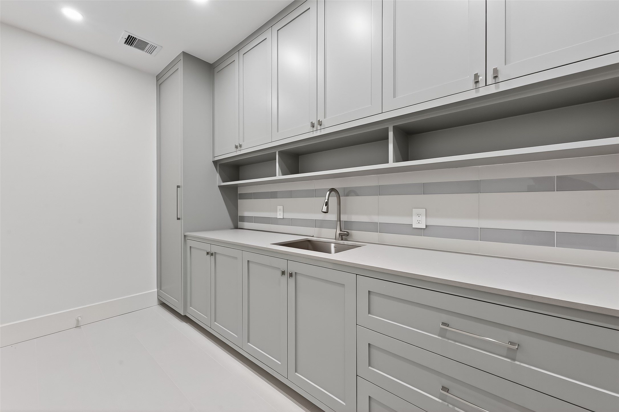6534 Corbin Street Houston, TX 77055 - Photo 10 of 50 Spacious laundry room with custom cabinetry and ample storage.