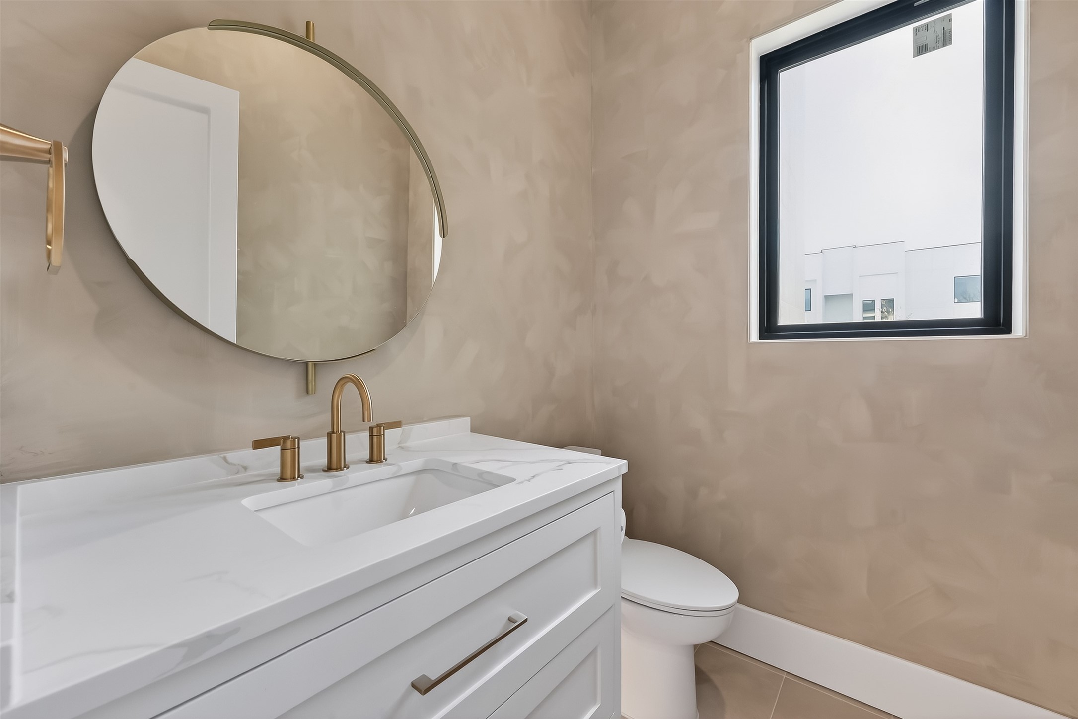 6534 Corbin Street Houston, TX 77055 - Photo 14 of 50 Stylish powder bath on the first floor features a floating vanity, quartz counter, and designer fixtures and wall paint finish.