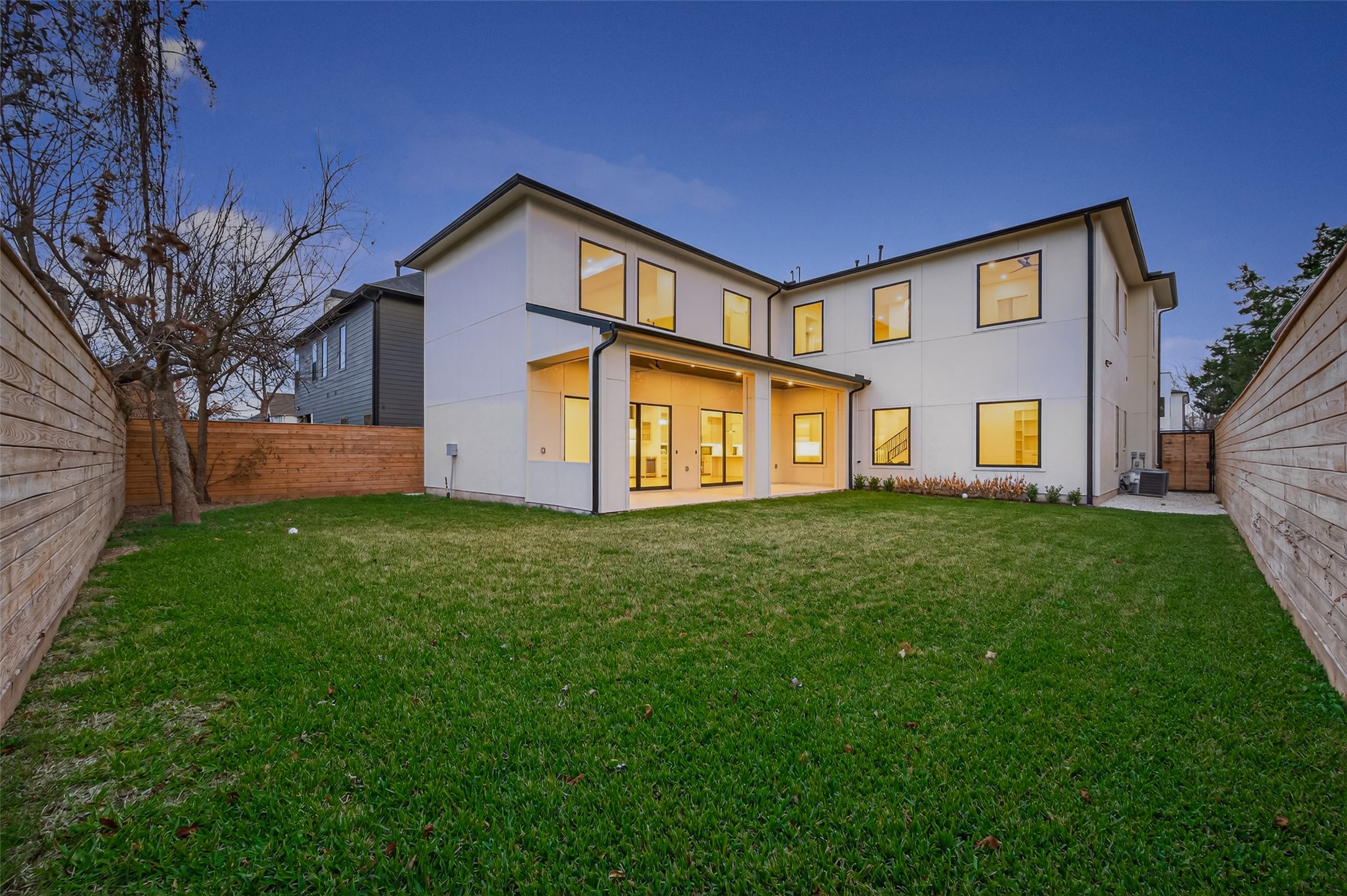 6534 Corbin Street Houston, TX 77055 - Photo 16 of 50 Expansive backyard with covered patio and large windows overlooking the lawn.