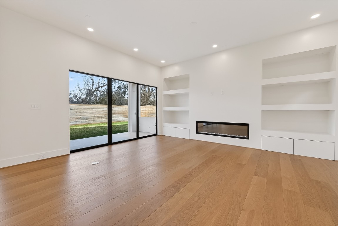 6534 Corbin Street Houston, TX 77055 - Photo 20 of 50 a view of an empty room with wooden floor and windows