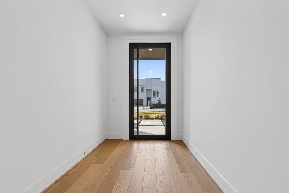 6534 Corbin Street Houston, TX 77055 - Photo 25 of 50 a view of empty room with wooden floor and door