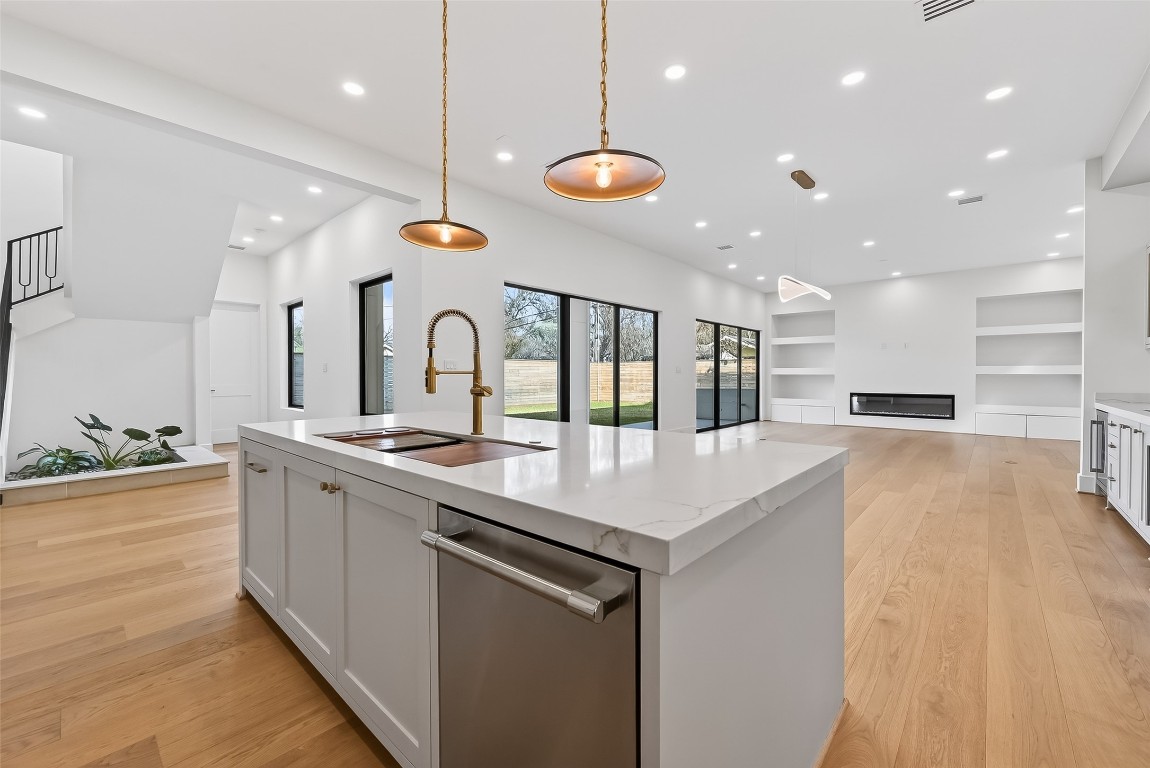 6534 Corbin Street Houston, TX 77055 - Photo 3 of 50 a large kitchen with stainless steel appliances kitchen island a large counter top a stove and a chandelier