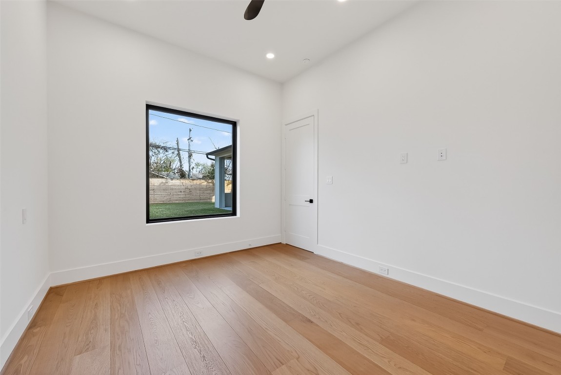 6534 Corbin Street Houston, TX 77055 - Photo 33 of 50 a view of an empty room with wooden floor and a window