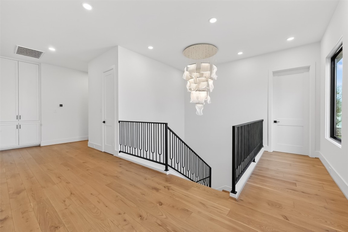 6534 Corbin Street Houston, TX 77055 - Photo 34 of 50 a view of an empty room with wooden floor and windows