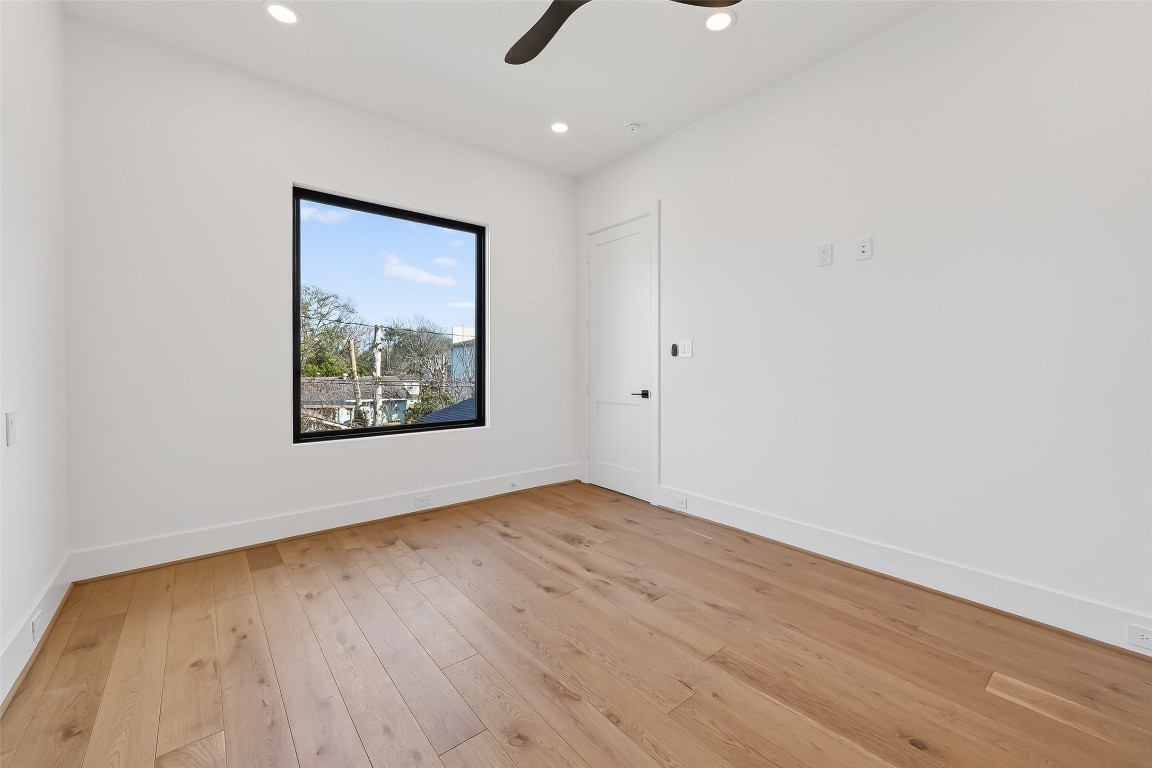 6534 Corbin Street Houston, TX 77055 - Photo 35 of 50 an empty room with wooden floor and painting on the wall