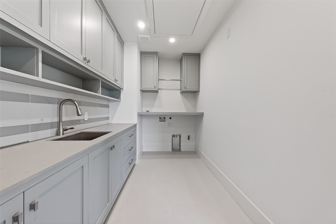 6534 Corbin Street Houston, TX 77055 - Photo 37 of 50 a kitchen with a sink stainless steel appliances and cabinets