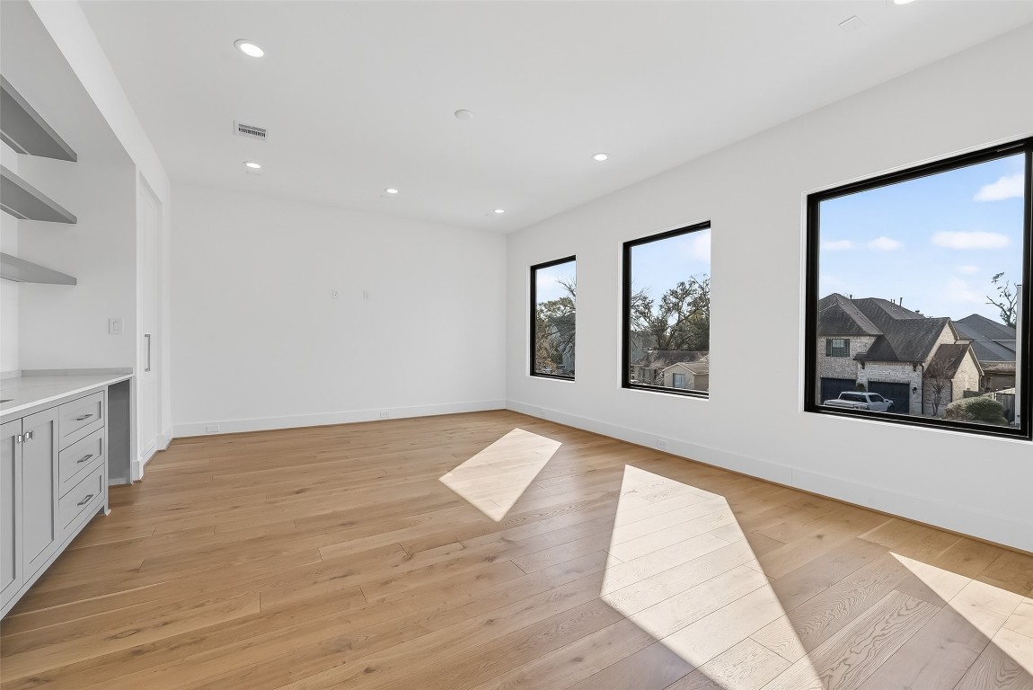 6534 Corbin Street Houston, TX 77055 - Photo 38 of 50 a view of hallway with wooden floor and windows