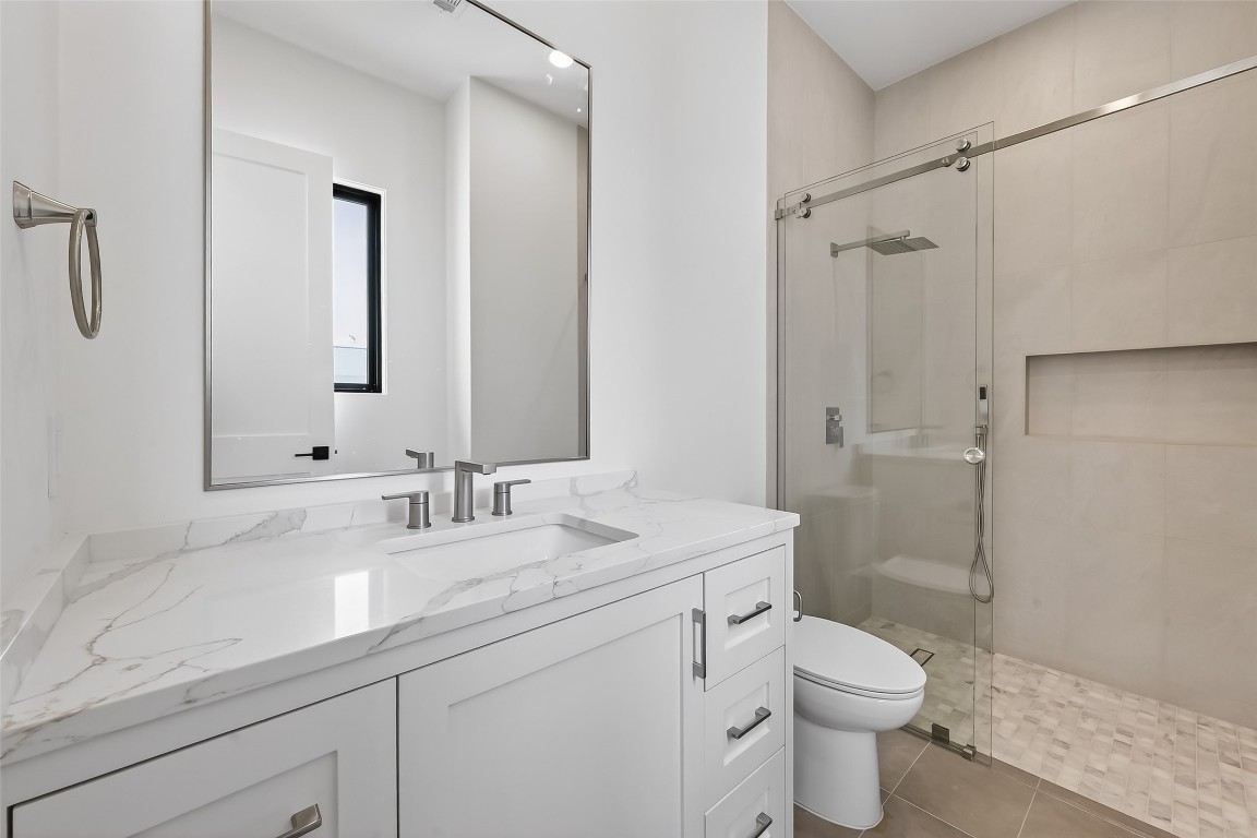 6534 Corbin Street Houston, TX 77055 - Photo 43 of 50 a bathroom with a sink a toilet a shower and a mirror