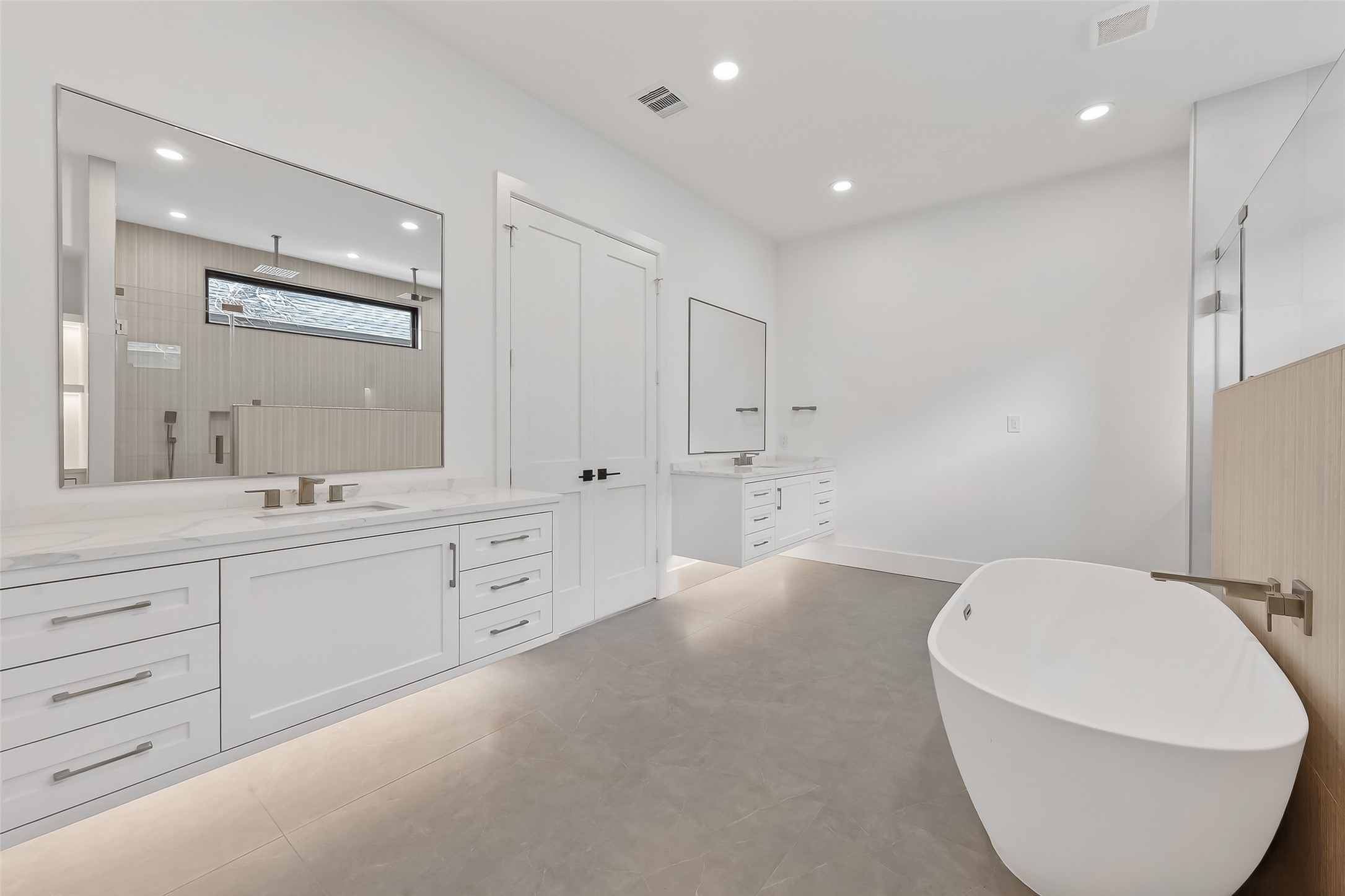 6534 Corbin Street Houston, TX 77055 - Photo 5 of 50 Spa-like primary bath with floating dual vanities and freestanding tub.