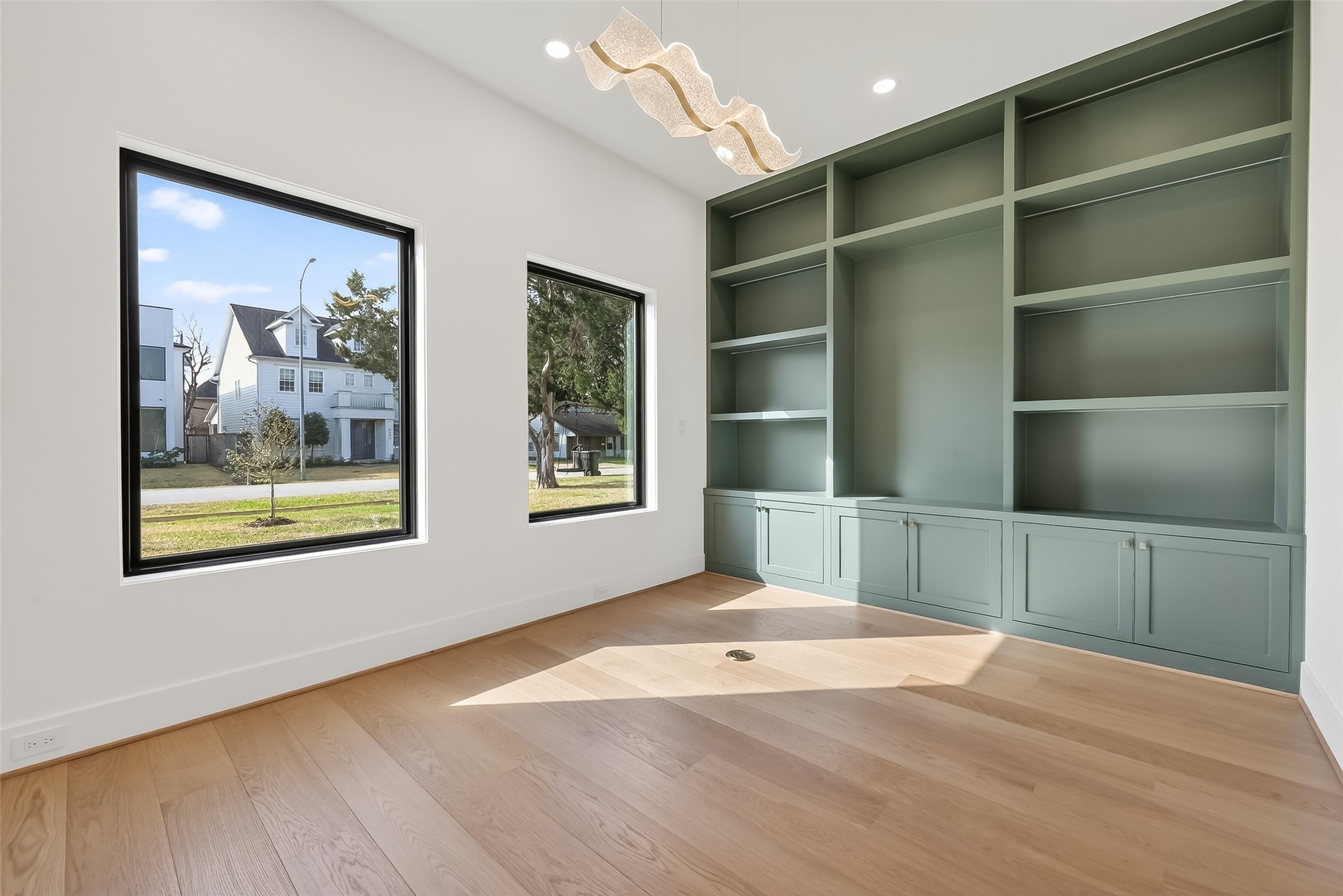 6534 Corbin Street Houston, TX 77055 - Photo 6 of 50 Private home office with built-in shelves, designer lighting, and large windows.