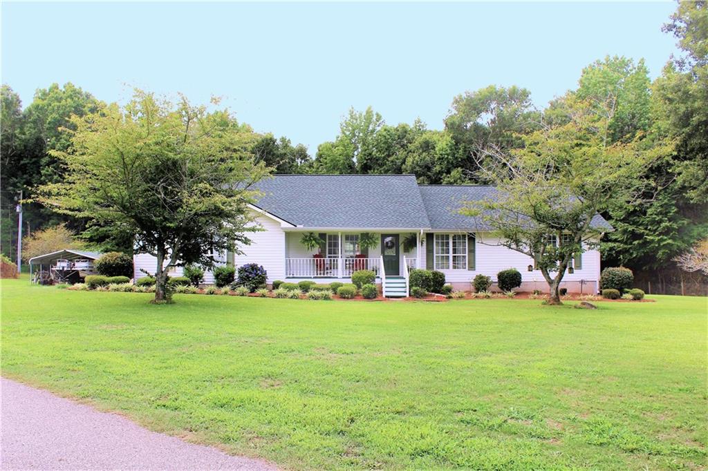 102 Neese Commerce Road Commerce, GA 30530 - Photo 1 of 1 a view of a house with a big yard and large trees