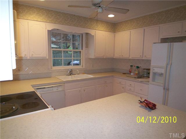 218 Northfield Drive Raleigh, NC 27609 - Photo 3 of 7 a kitchen with granite countertop a sink stainless steel appliances and cabinets