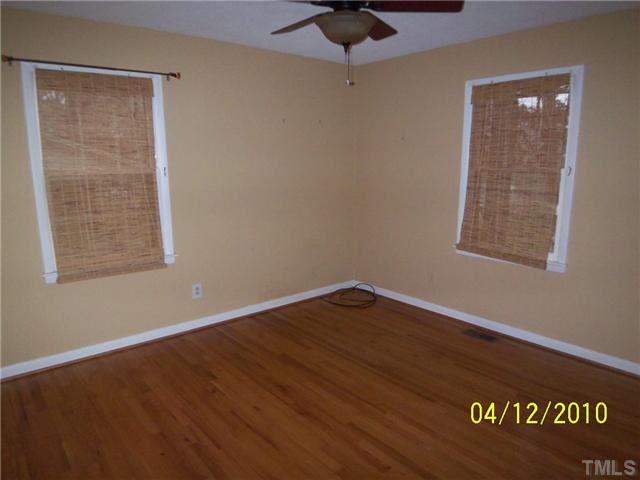 218 Northfield Drive Raleigh, NC 27609 - Photo 6 of 7 an empty room with wooden floor and windows