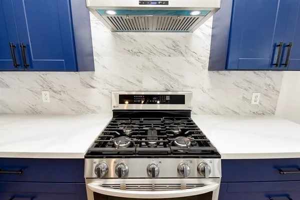 a stove sitting inside of a kitchen