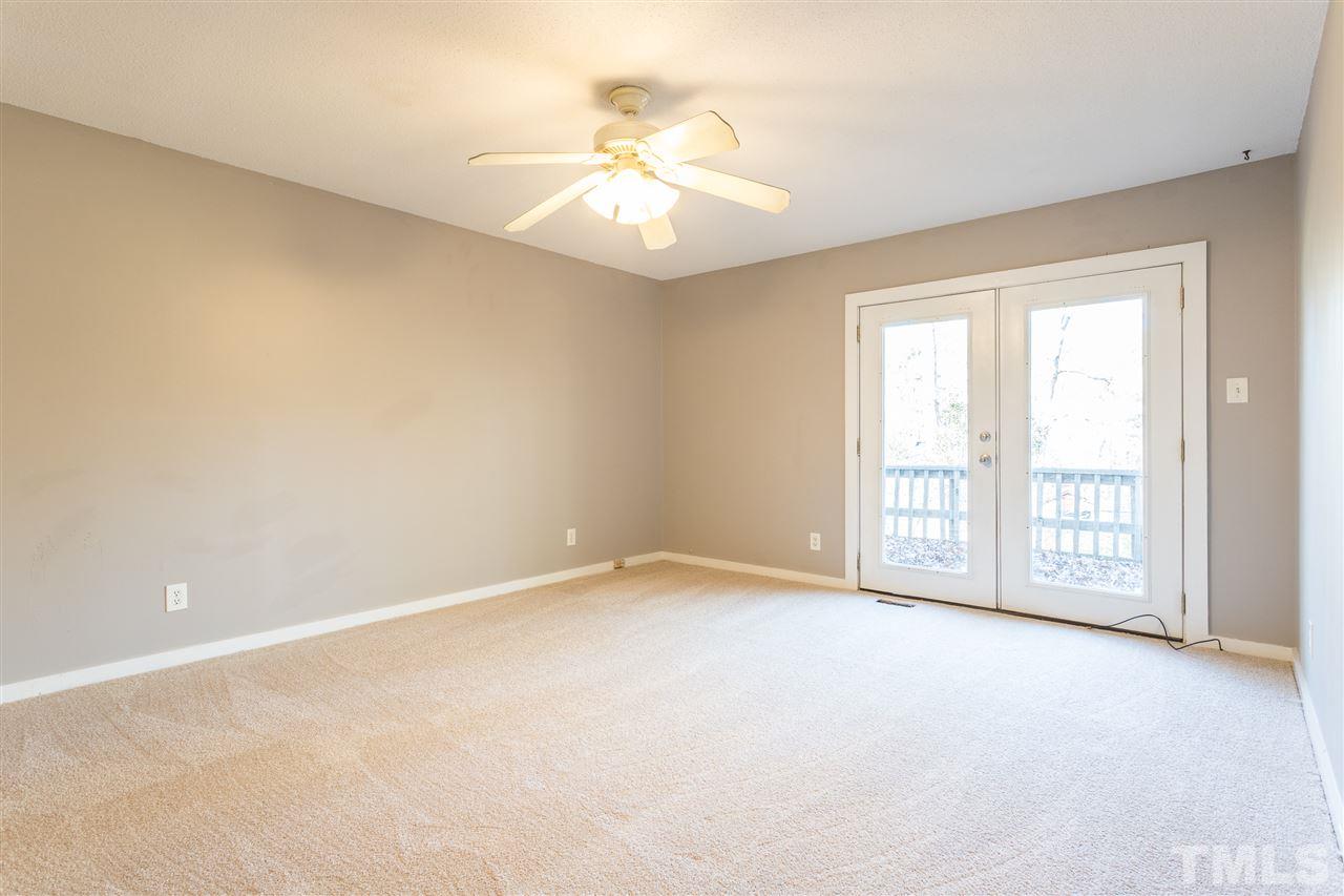 2004 Brocton Place Durham, NC 27712 - Photo 16 of 29 an empty room with chandelier fan and windows