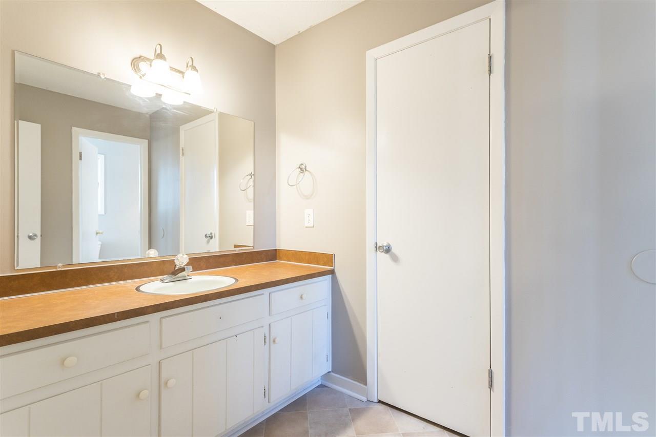 2004 Brocton Place Durham, NC 27712 - Photo 18 of 29 a spacious bathroom with a granite countertop sink a mirror and a shower