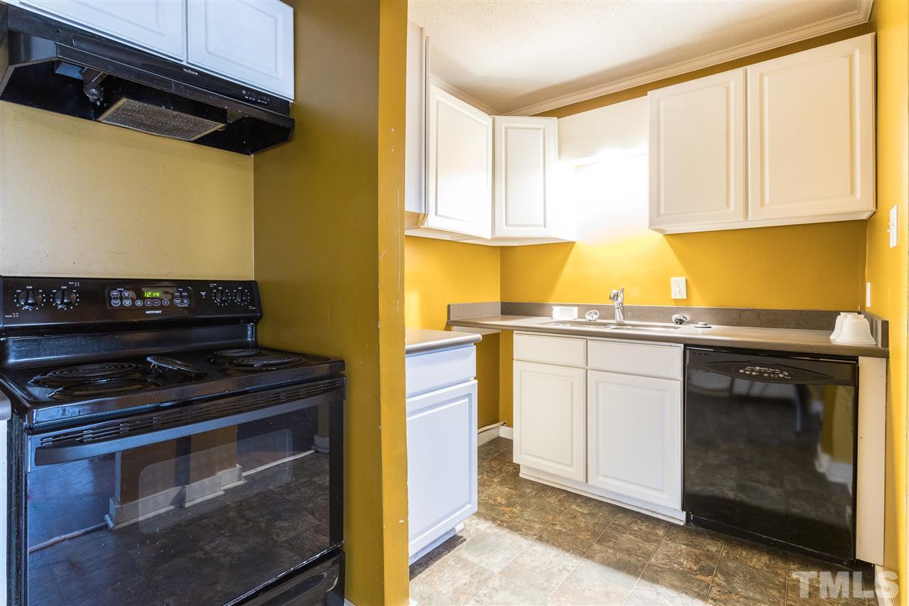 2004 Brocton Place Durham, NC 27712 - Photo 27 of 29 a kitchen with stainless steel appliances granite countertop a stove and a microwave