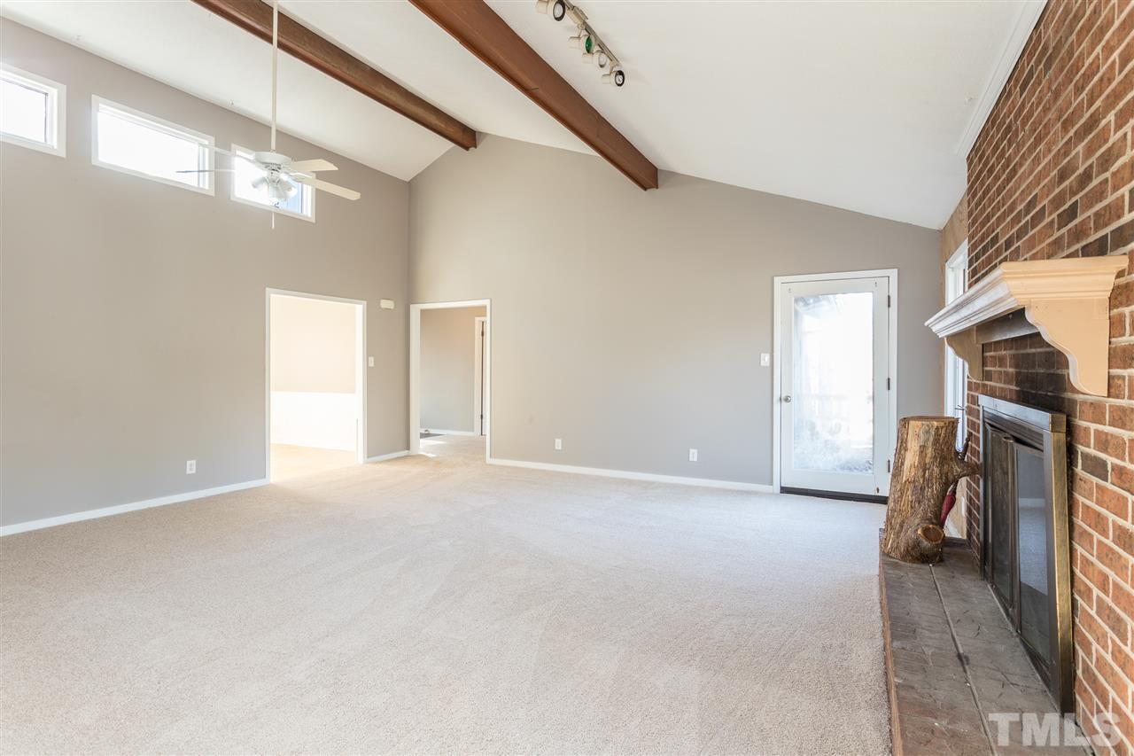 2004 Brocton Place Durham, NC 27712 - Photo 4 of 29 a view of empty room with stairs and hardwood floor